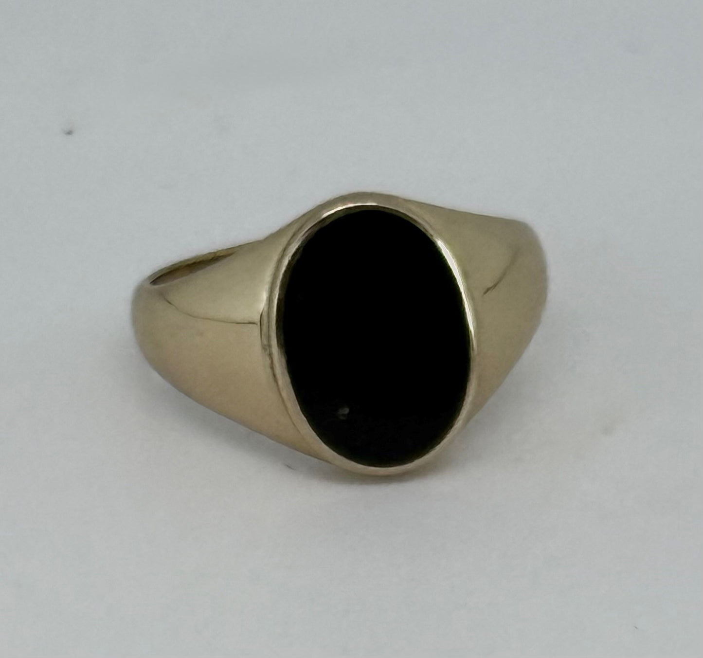 Oval black stone brass ring